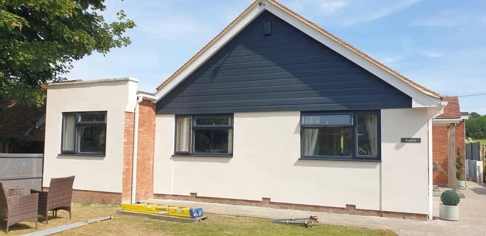 Exterior cladding finished in a dark sprayed colour