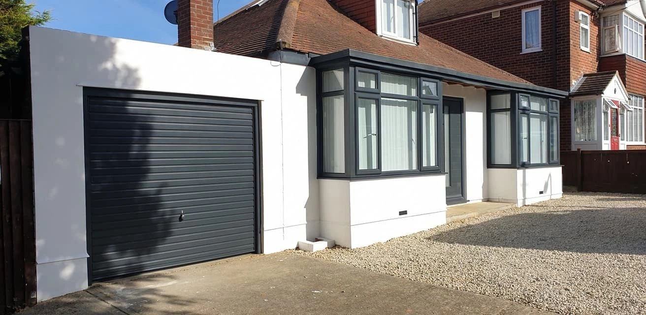 House frontage with sprayed windows and garage door