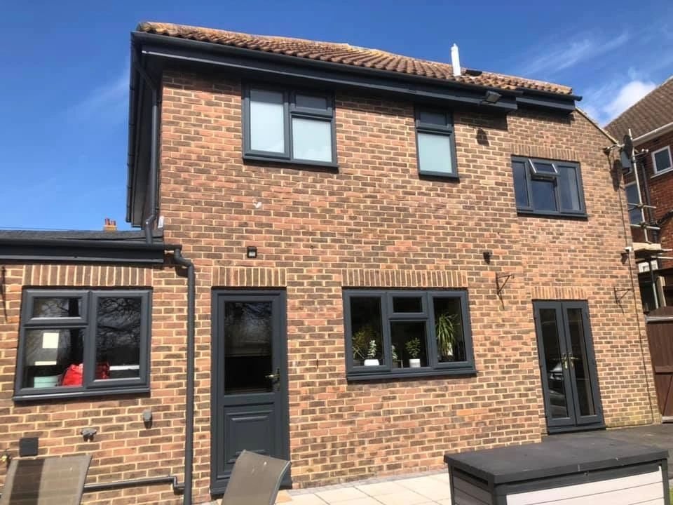 Rear brick home with sprayed black window frames